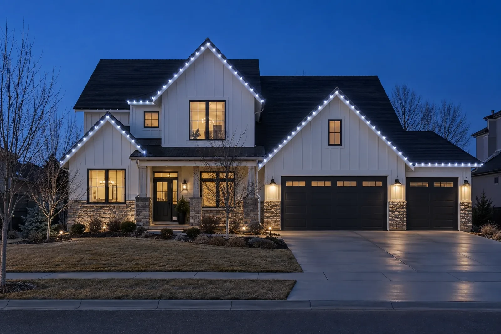 A two-story with crisp cool white C9 lights on the roofline and gables